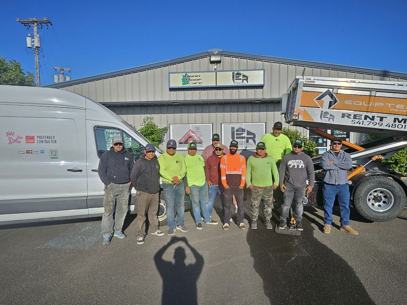The Bonn Roof Care crew standing together outside the company shop in Eugene